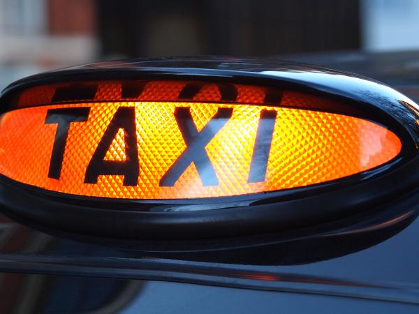 Image of a black cab taxi sign