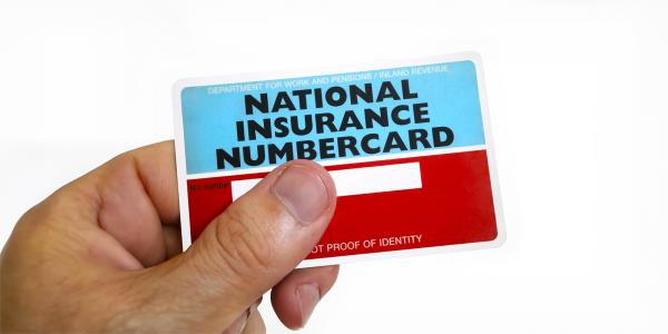 a person holding a national insurance numbercard.