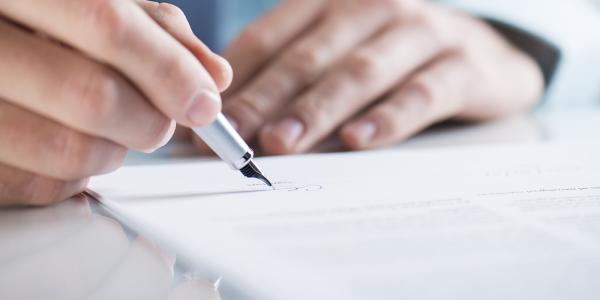 a person signing a document 