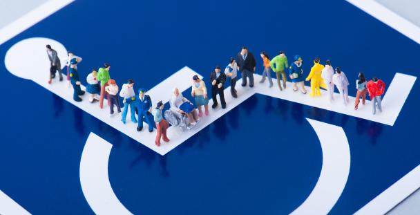 Image of the disability sign with models of people standing on it Image of the disability sign with models of people standing on it