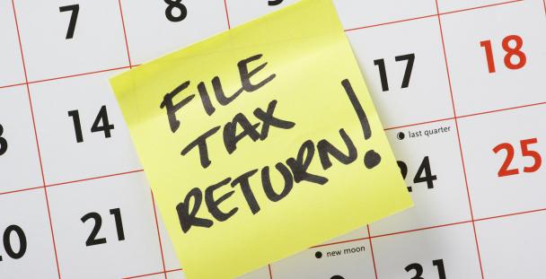 Image of a sticky note saying file tax return Image of a sticky note saying file tax return