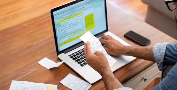 Employment expenses - claim tax back online man checking expenses to claim tax back online