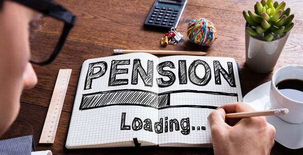 Image of a man writing pension... loading in a notebook Image of a man writing pension... loading in a notebook