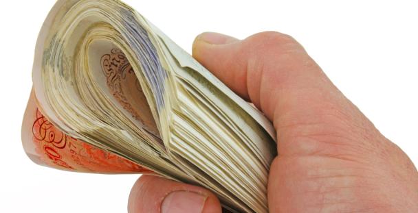 Image of a person holding UK bank notes Image of a person holding UK bank notes