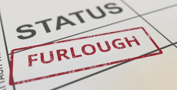 The word furlough stamped on a piece of paper The word furlough stamped on a piece of paper