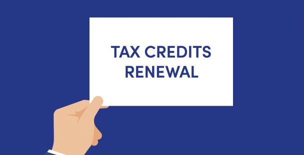 Illustration of a hand holding a sign saying tax credits renewal