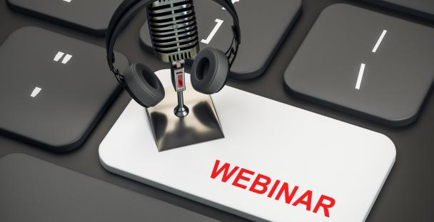 Image of webinar button on a keyboard with a microphone and headphones Image of webinar button on a keyboard with a microphone and headphones
