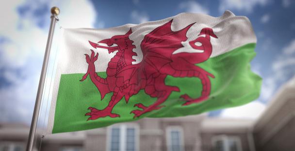 Image of the Welsh flag in front of a building Image of the Welsh flag in front of a building