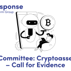 LITRG Response: Treasury Committee: Cryptoasset industry – Call for Evidence. image of a small robot coming out of a mobile phone offering crypto currency to the lady sat on a beanbag playing on her laptop. 