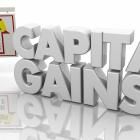 Image of the words capital gains and a for sale sign
