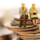 Image of models of pensioners sitting on a pile of coins