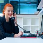 Woman talking on a telephone.