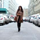Woman walking in the middle of a road.