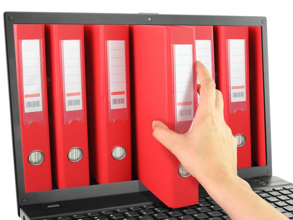 A laptop screen showing various red folders, a person is reaching into the screen to retrieve one of the files.