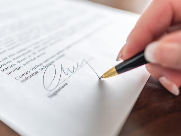 A person signing an important legal document