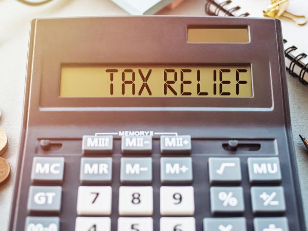 a calculator with the words 'TAX RELIEF' typed on it. 