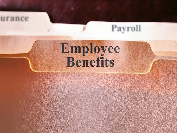 folders in a filing cabinet, the front folder reads 'EMPLOYEE BENEFITS' others behind this read 'INSURANCE', 'PAYROLL' and 'MISC'.