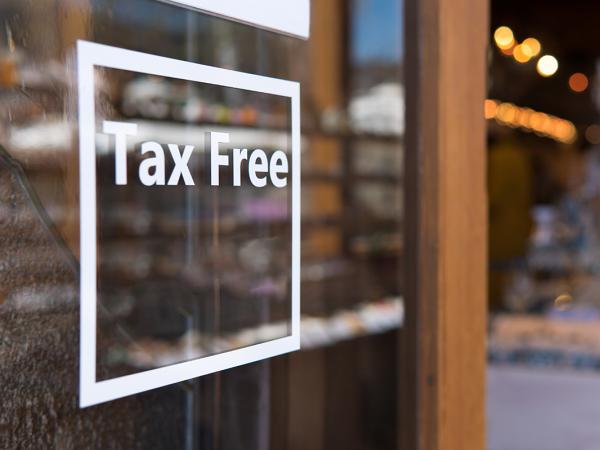 an open glass door with the words 'TAX FREE' written on it in white text