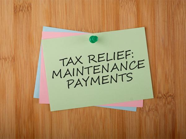 a pile of post-it notes pinned to a board, the top note reads 'TAX RELIEF: MAINTENANCE PAYMENTS'