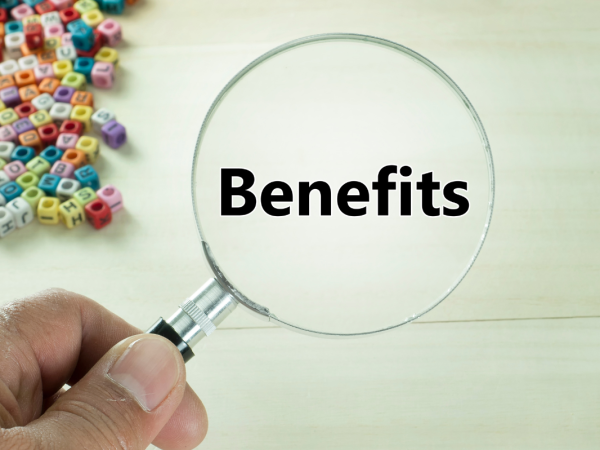 a person holding a magnifying glass which reads 'BENEFITS' scattered across the top left are small coloured beads with letters on. 