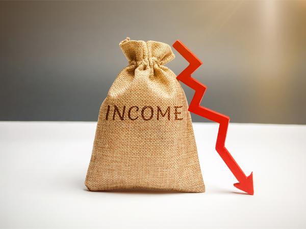 a brown sack with the word 'INCOME' on the front, propped next to the sack is a crooked red arrow pointing downwards