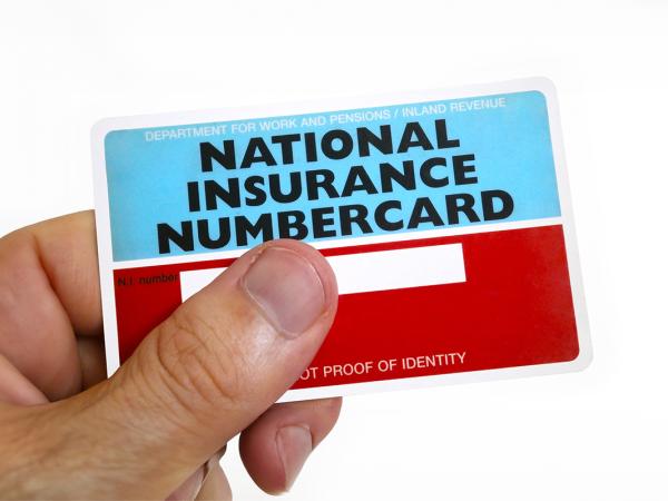 a person holding a national insurance numbercard.
