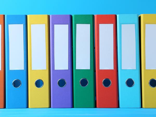 8 coloured folders lined up against a light blue background.