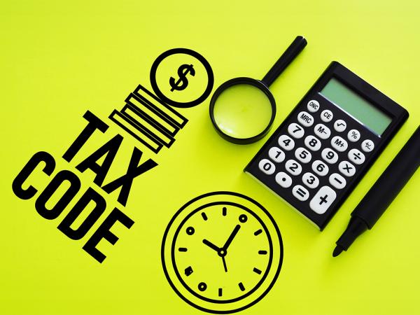 a calculator, marker pen and magnifying glass against a lime green background, drawn on the green background are the words 'TAX CODE', a stack of coins, and a clock. 