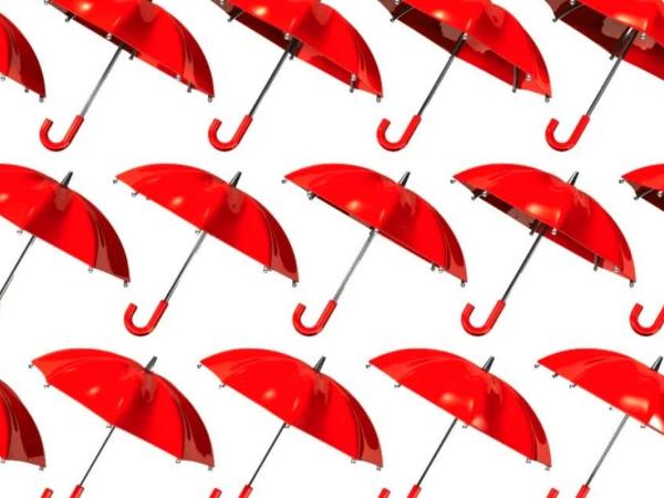 Many red umberella's against a white background