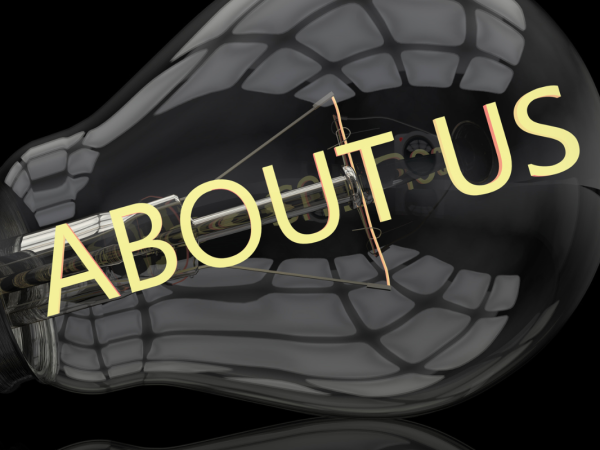 A black background with a lightbulb visible, across the lightbulb the words 'ABOUT US' can be seen in yellow text.