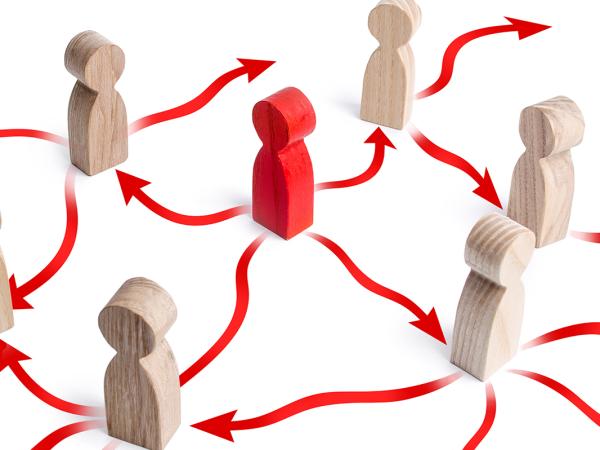 6 brown wooden figures surround 1 red figure, the white floor is filled with red arrows each pointing in a different direction. 