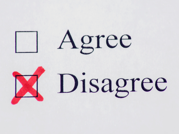 Typed words in black ink on paper 'AGREE', 'DISAGREE' next to each word is a check box. The box against the word 'DISAGREE' is checked with a red cross.