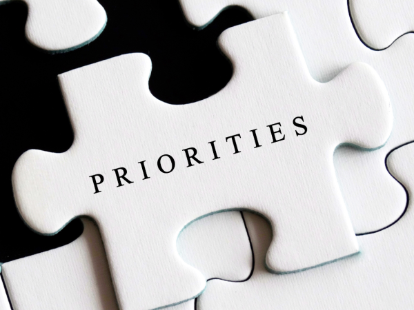 a white jigsaw, the one missing piece has the word 'PRIORITIES' on it in black text. a white jigsaw, the one missing piece has the word 'PRIORITIES' on it in black text.