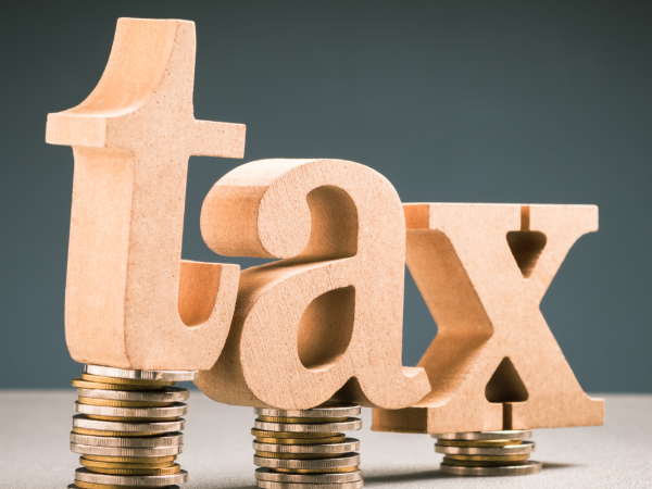 the word 'TAX' sat on top of piles of coins. 