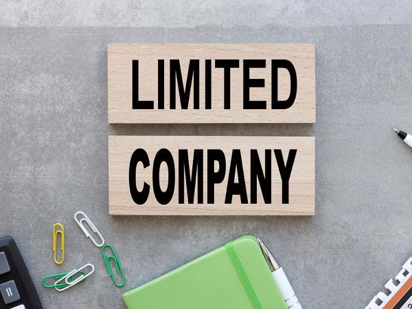 Various stationary scattered on a desk with the words 'LIMITED COMPANY' in the centre.