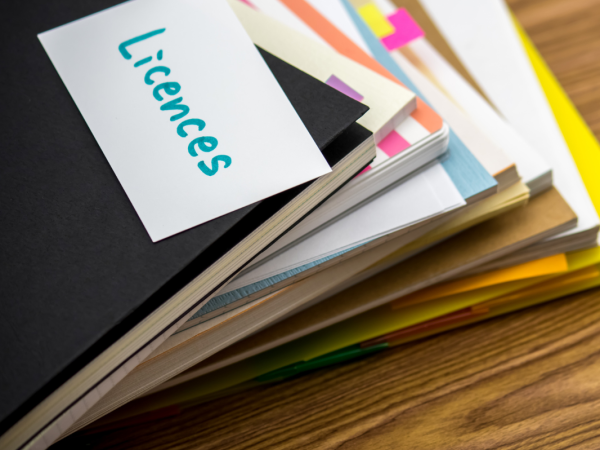 Folder full of paperwork, the front of the folder has a note saying 'LICENCES'. 