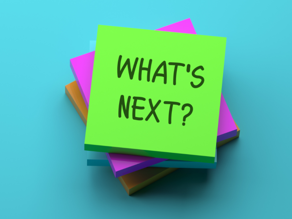 Pile of post it notes, the top note reads 'WHATS NEXT?'