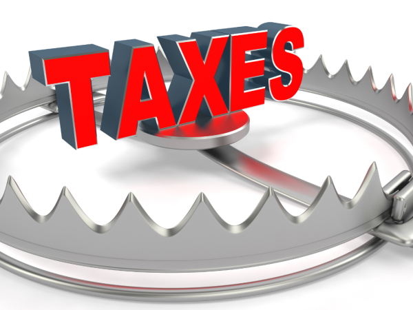 a bear trap set with the word 'TAXES' in the centre