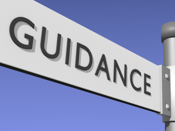 a white street sign with the word 'GUIDANCE' on it in black text a white street sign with the word 'GUIDANCE' on it in black text