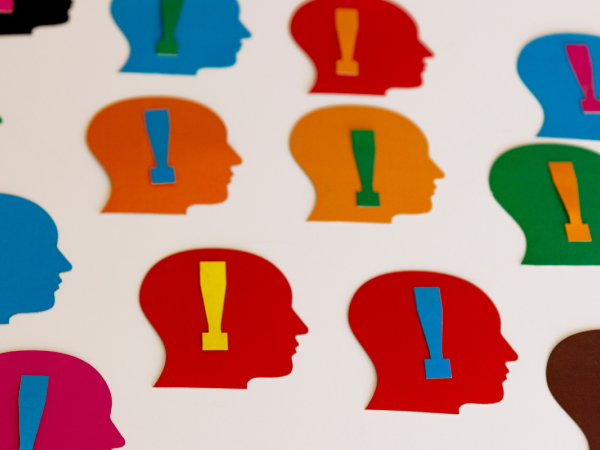 various coloured heads with a colourful exclamation mark inside 