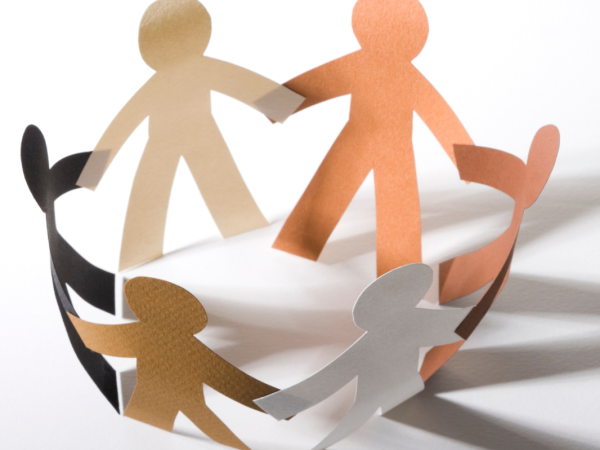 paper figures standing in a circle holding hands.