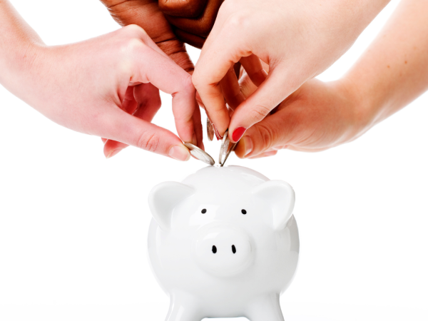 white piggy bank with people putting coins inside