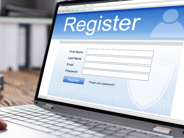 A laptop showing a registration screen.