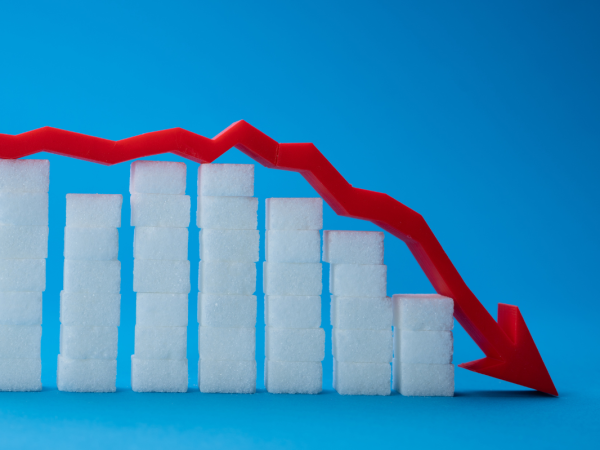stacks of sugar cubes gradually getting smaller with a red arrow laying across the top of them pointing downwards at the end. 