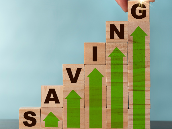 6 piles of wooden blocks each with a green arrow pointing upwards the block on top of each pile has a letter on, together spelling out the word 'SAVING'