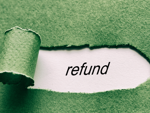 A green piece of paper with a tear in it revealing a white paper beneath, the white paper seen through the rip has the word 'REFUND' typed on it. A green piece of paper with a tear in it revealing a white paper beneath, the white paper seen through the rip has the word 'REFUND' typed on it.