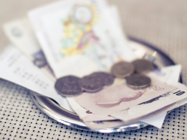 A receipt with cash placed on top in GBP A receipt with cash placed on top in GBP