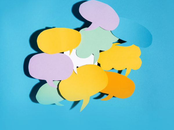 various colours and shapes of speech and thought bubbles against a blue background