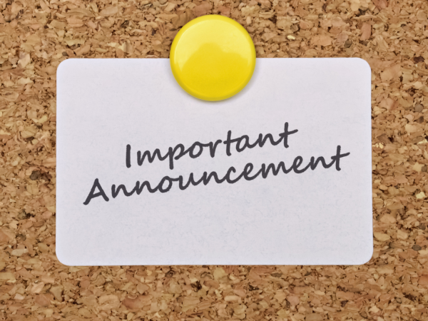 A brown pin board with a white card fixed onto it, the card reads 'IMPORTANT ANNOUNCEMENT' 