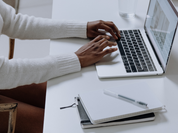 A person typing on a laptop A person typing on a laptop